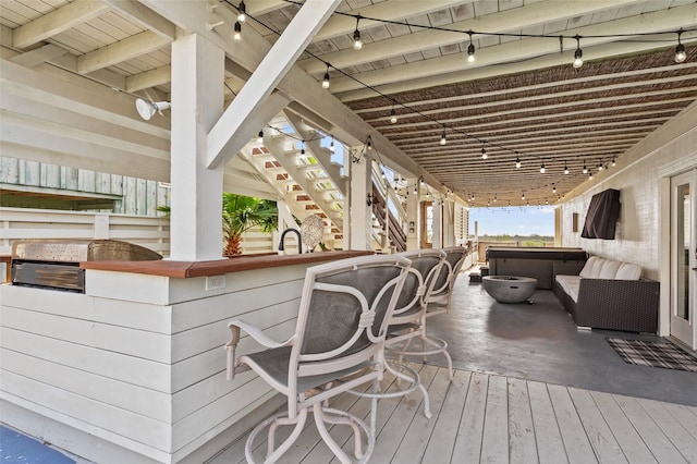 wooden terrace featuring outdoor dry bar, stairway, and grilling area