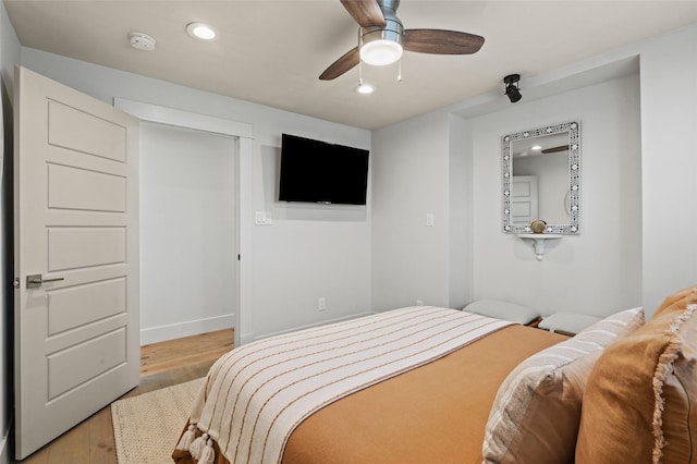 bedroom with wood finished floors, a ceiling fan, and recessed lighting