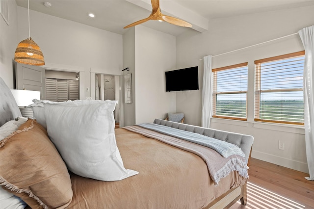 bedroom with recessed lighting, lofted ceiling with beams, a ceiling fan, wood finished floors, and baseboards