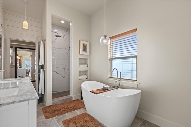 full bath featuring a freestanding tub, baseboards, vanity, and a marble finish shower