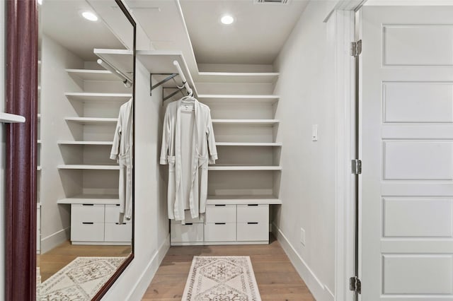 spacious closet featuring wood finished floors and visible vents