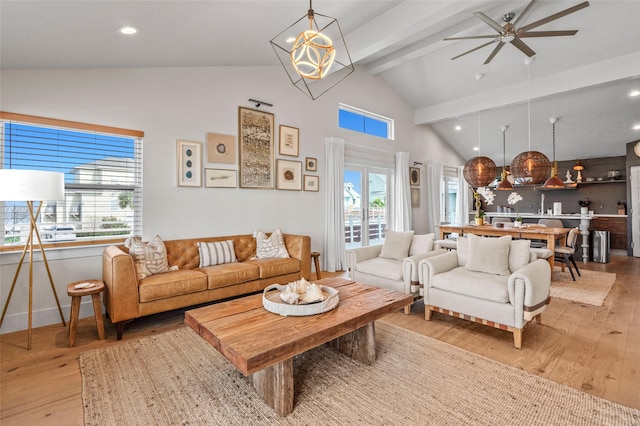 living room featuring high vaulted ceiling, beamed ceiling, recessed lighting, and light wood-style floors