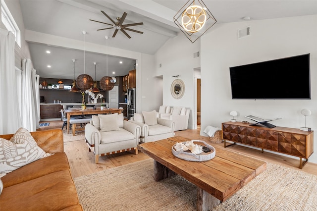 living area with light wood-style flooring, visible vents, beam ceiling, and ceiling fan with notable chandelier