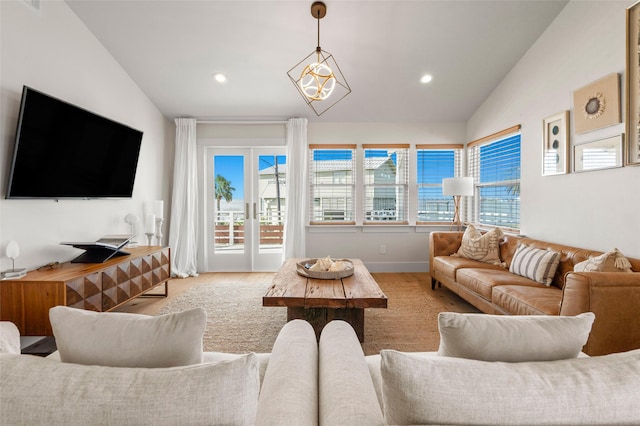 living room featuring lofted ceiling, visible vents, and recessed lighting