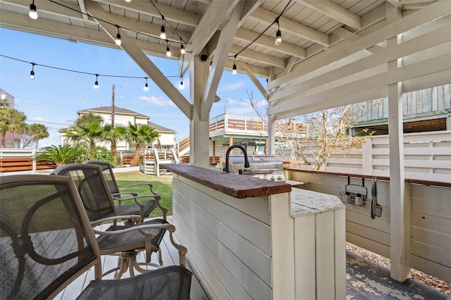 exterior space featuring a grill and outdoor dry bar