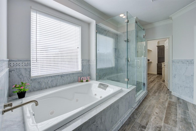 full bath with a stall shower, ornamental molding, wood finished floors, a jetted tub, and a spacious closet