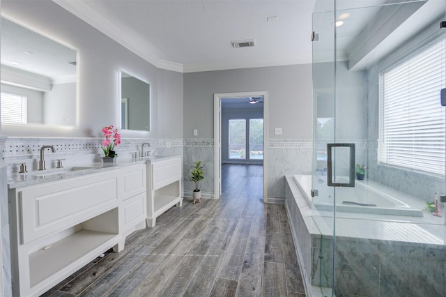 full bathroom with double vanity, visible vents, a sink, and wood finished floors