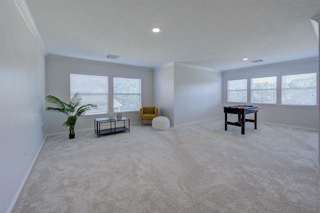 rec room with a healthy amount of sunlight, carpet floors, baseboards, and ornamental molding