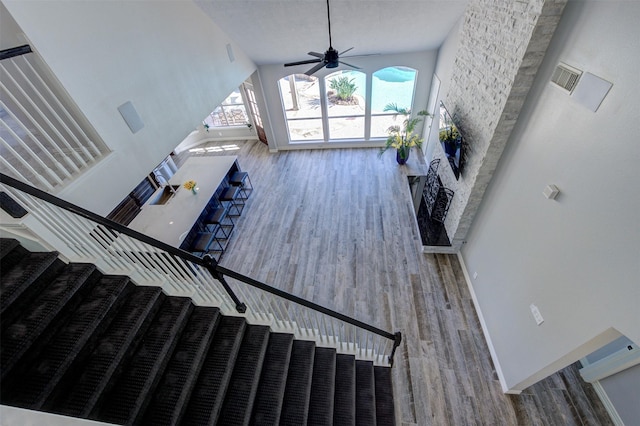 staircase featuring baseboards, a wealth of natural light, and wood finished floors