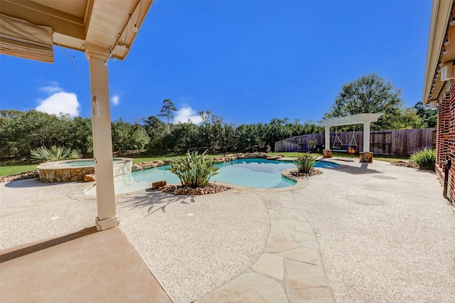 view of swimming pool with a patio area, a fenced backyard, and a pool with connected hot tub