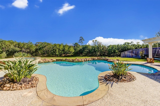 view of swimming pool featuring a lawn, a fenced in pool, an in ground hot tub, fence, and a patio area