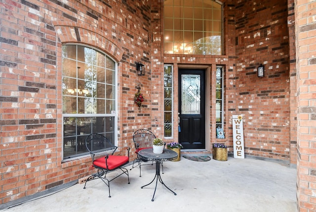 doorway to property with brick siding