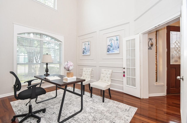 office featuring a wealth of natural light, dark wood-style floors, and baseboards