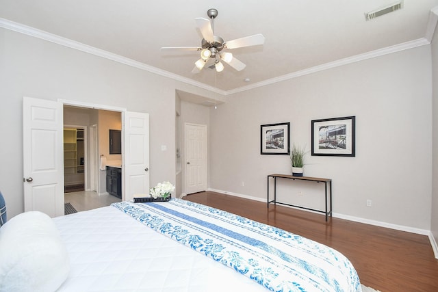 bedroom featuring visible vents, ornamental molding, baseboards, and wood finished floors