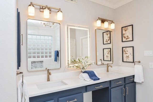 full bath with double vanity, visible vents, and a sink