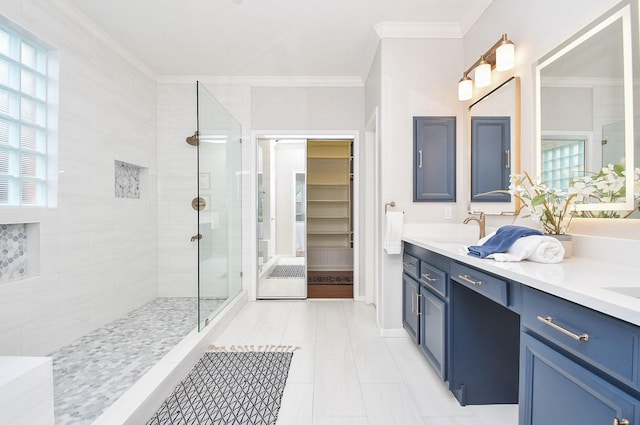 full bathroom featuring a sink, tiled shower, ornamental molding, and double vanity