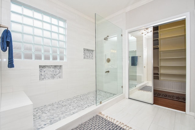 bathroom with tile patterned floors, walk in shower, and ornamental molding