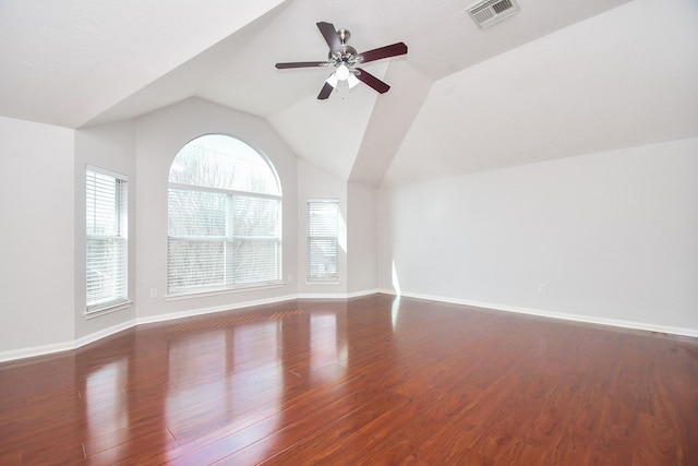 unfurnished living room featuring visible vents, a ceiling fan, wood finished floors, baseboards, and lofted ceiling