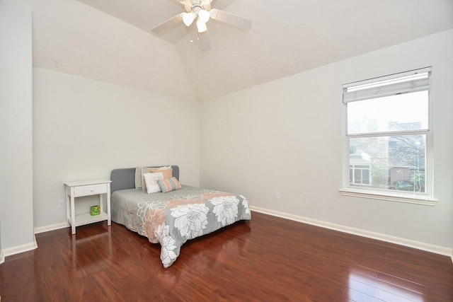 bedroom featuring ceiling fan, baseboards, lofted ceiling, and wood finished floors