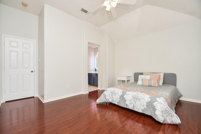 bedroom with visible vents, lofted ceiling, baseboards, and wood finished floors