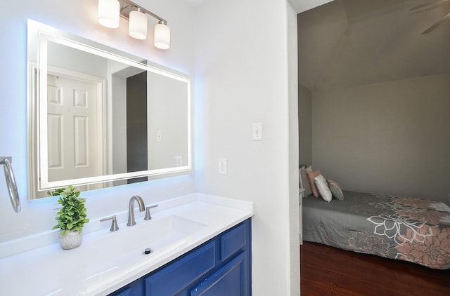 bathroom with vanity, a ceiling fan, and wood finished floors