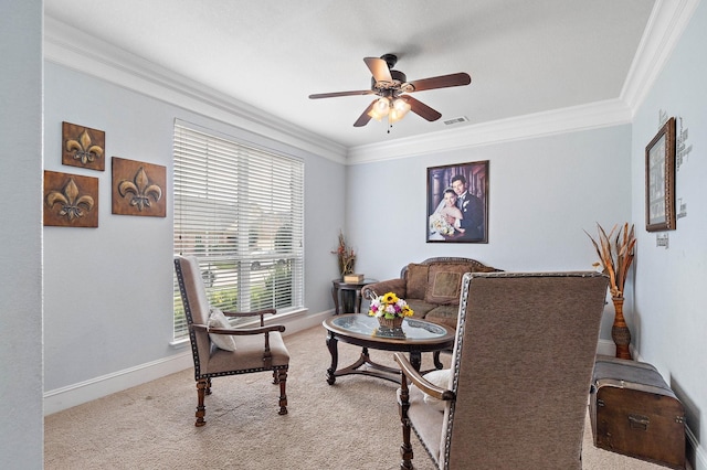 carpeted living area featuring baseboards, visible vents, a ceiling fan, and ornamental molding