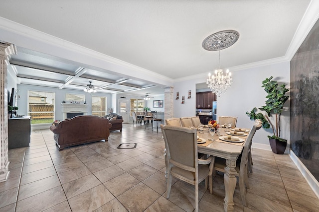 dining space with ceiling fan with notable chandelier, a fireplace, coffered ceiling, and a healthy amount of sunlight