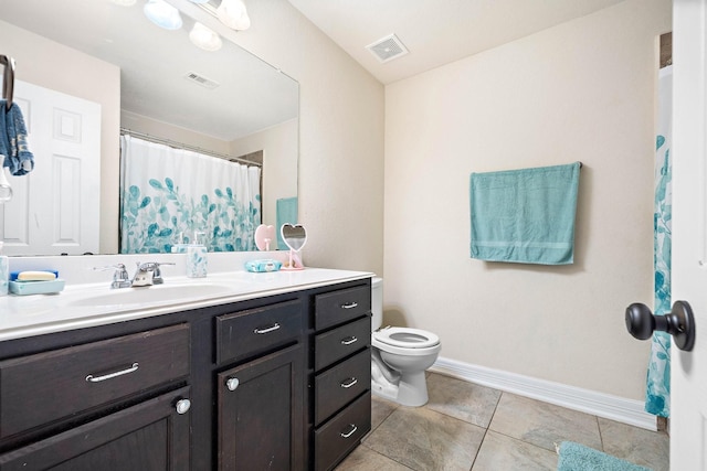 bathroom featuring tile patterned flooring, vanity, visible vents, and baseboards