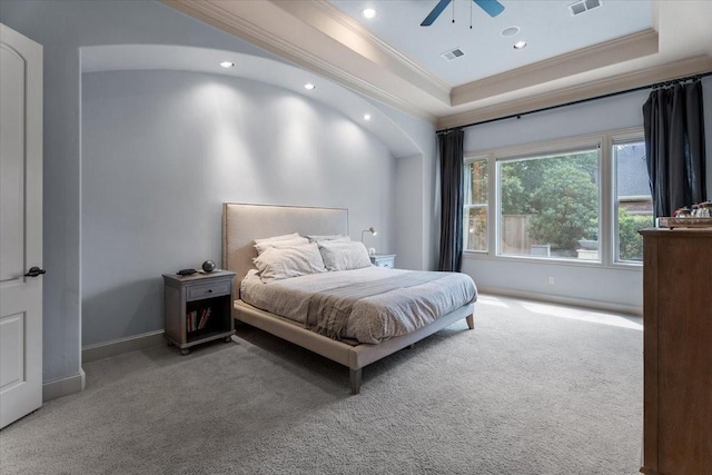 carpeted bedroom with visible vents, baseboards, a tray ceiling, ornamental molding, and recessed lighting