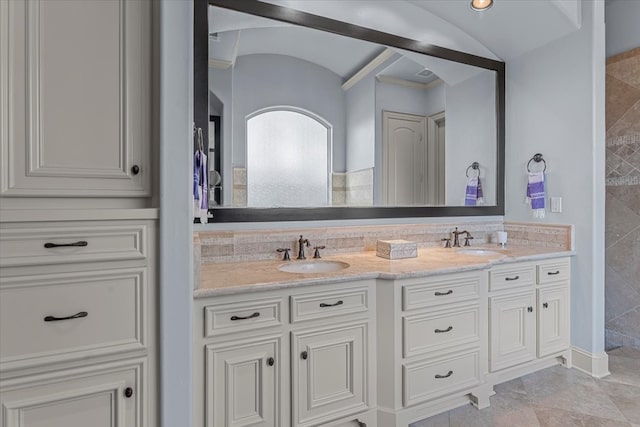 bathroom with a sink and double vanity