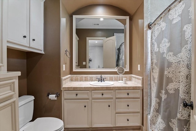 bathroom featuring visible vents, toilet, ornamental molding, a shower with shower curtain, and vanity