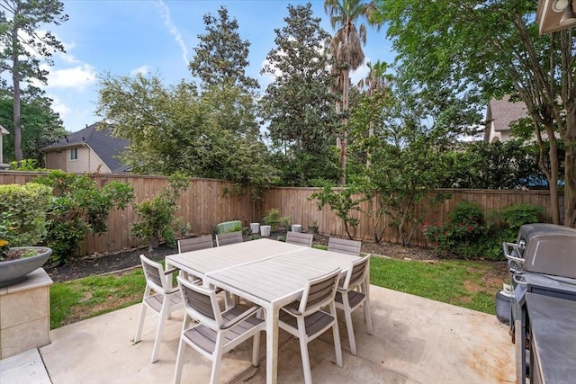 view of patio with outdoor dining area and a fenced backyard