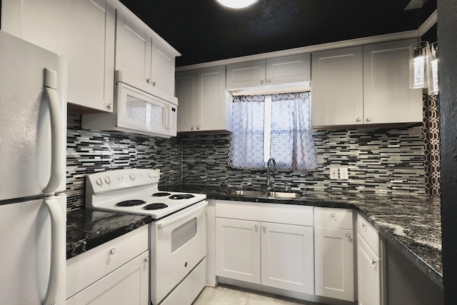 kitchen featuring white appliances, tasteful backsplash, a sink, and light tile patterned flooring