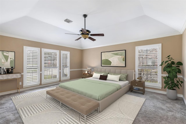 carpeted bedroom featuring visible vents, lofted ceiling, a ceiling fan, crown molding, and baseboards