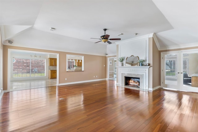 unfurnished living room featuring visible vents, baseboards, a high end fireplace, ceiling fan, and wood-type flooring