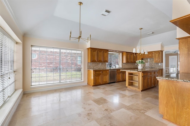 kitchen featuring visible vents, brown cabinets, stainless steel dishwasher, lofted ceiling, and a chandelier