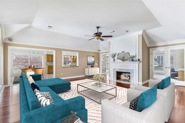 living room with a fireplace, wood finished floors, visible vents, and baseboards