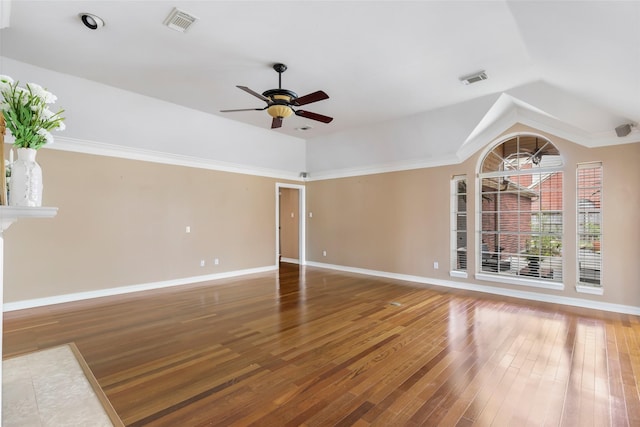 empty room with ceiling fan, wood finished floors, visible vents, and baseboards