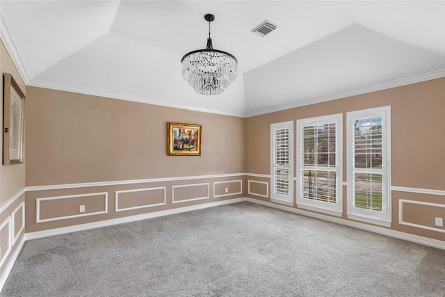 carpeted empty room with visible vents, vaulted ceiling, crown molding, a decorative wall, and a chandelier