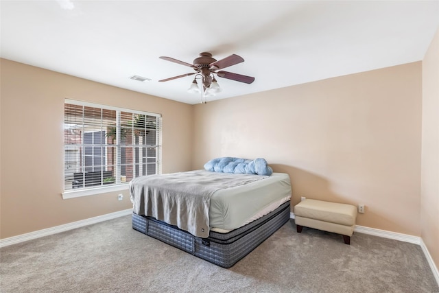 carpeted bedroom featuring visible vents, baseboards, and ceiling fan