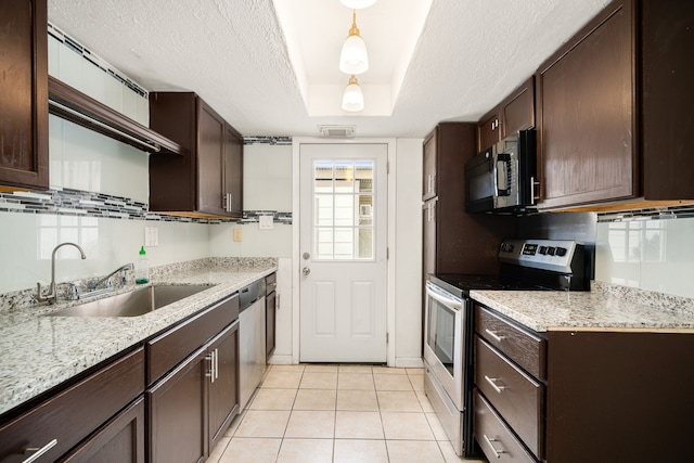 kitchen with visible vents, appliances with stainless steel finishes, a textured ceiling, dark brown cabinets, and a sink