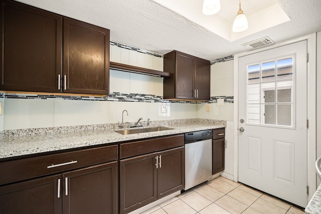 kitchen with dark brown cabinetry, light tile patterned floors, visible vents, dishwasher, and a sink