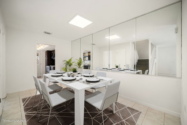 dining area featuring tile patterned flooring, visible vents, stairway, and baseboards