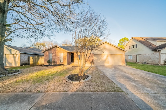 view of front of property with a garage, a front yard, brick siding, and driveway