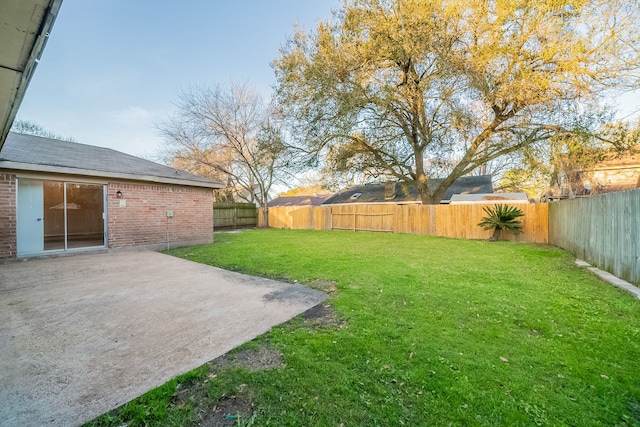 view of yard featuring a patio area and a fenced backyard