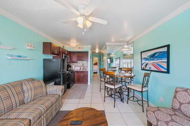 living area with light tile patterned floors, ceiling fan, visible vents, and crown molding