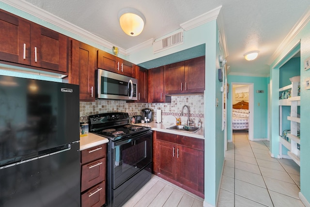 kitchen with crown molding, tasteful backsplash, visible vents, a sink, and black appliances