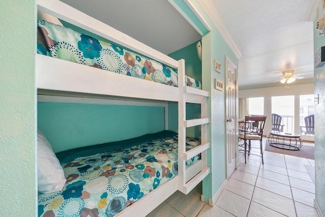 bedroom with tile patterned flooring, a textured ceiling, and crown molding