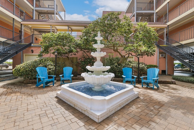 view of home's community with a patio area and stairs