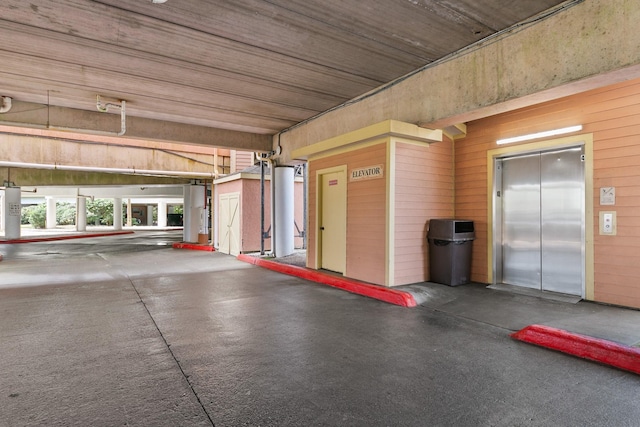 garage with wood walls and elevator